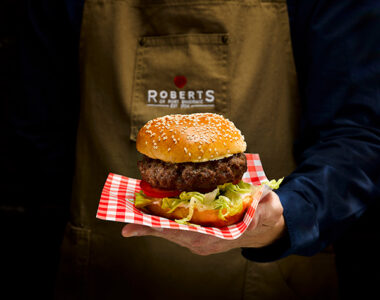 Chef holding burger - Roberts of Port Dinorwic